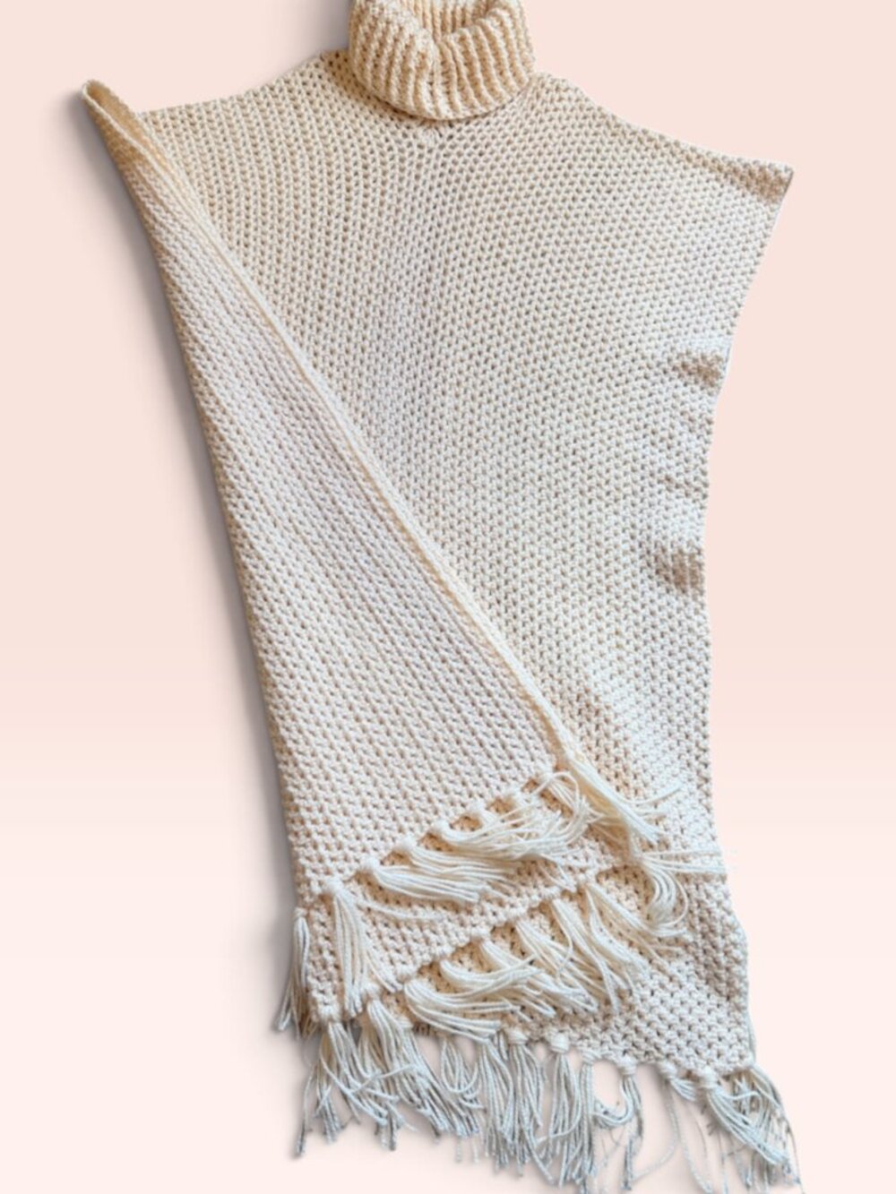 Cream-colored handmade crochet poncho with a mock neck